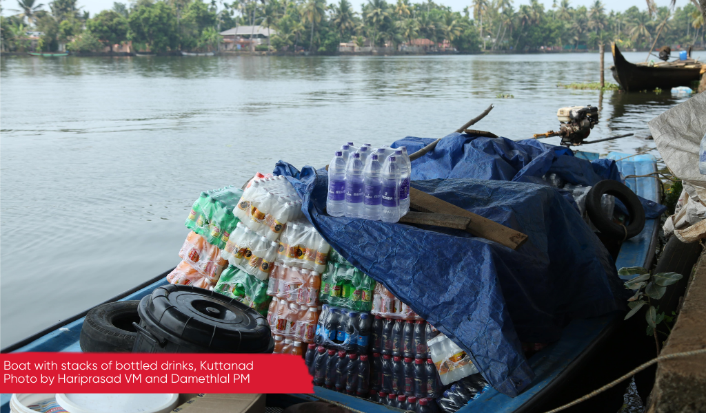 Plastic bottled drinks stacked on a small boat for sale, Kuttanad