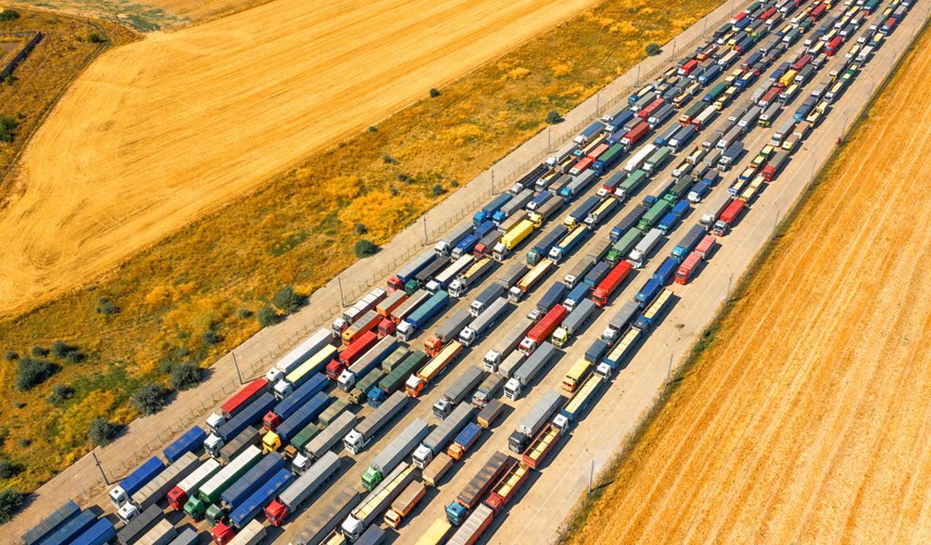 A long queue of trucks loaded with grain crops in a blocked Ukrainian port. 