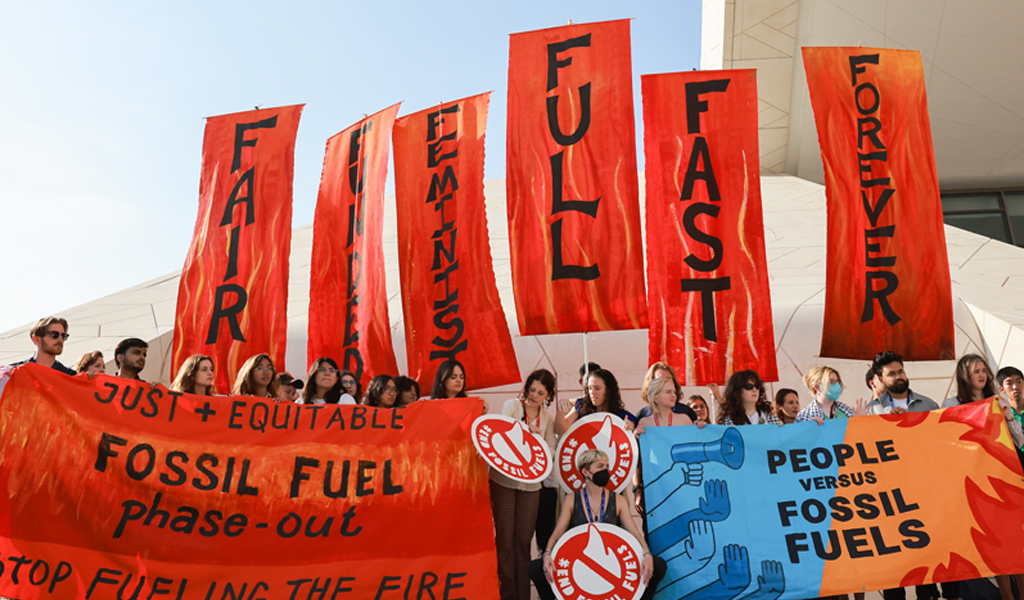 A photo of group of people holding climate change banners.